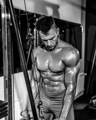Fototapeta na wymiar Young Bodybuilder Doing Heavy Weight Exercise For Triceps