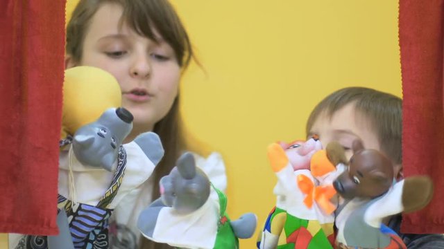 Adorable children playing with hand toys on puppet show