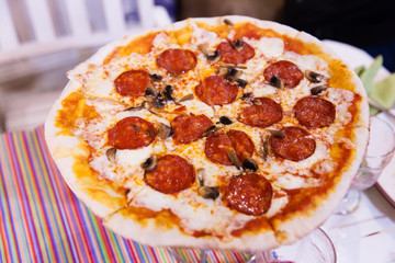 Pizza with salami, cheese and champignons