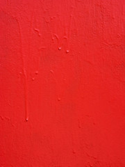 Red metal texture with a roughness and drops of paint surface. Grunge urban background.