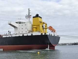 Products Tanker discharging at the Oil Terminal of Lorient, France, with black hull and yellow...