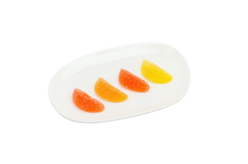 Naklejka na ściany i meble Bright multicolored marmalade on a plate isolated on a white background