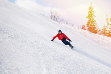 Fototapeta na wymiar athlete with a hard snowboard for slalom in a ski resort enters the turn, Murmansk region, Russia.