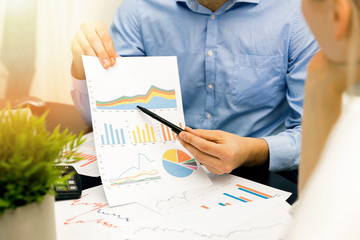 business people discussing graph and chart reports at office