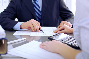 Obraz premium Bookkeepers or financial inspector making report, calculating or checking balance. Audit concept.