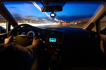 Night road view from inside car natural light street and other cars is motion blurred