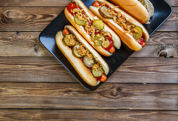 American hot dog with pickles,onions, ketchup and mustard