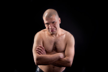 Fototapeta premium Muscular young man shirtless on a black background