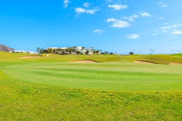 Obraz premium Green field and volcanic mountains near Las Playitas holiday village, Fuerteventura, Canary Islands, Spain