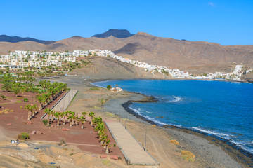 View of beach and bay with traditional white houses in village of Las Playitas, Fuerteventura, Canary Islands, Spain