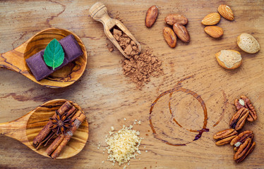Desserts background and menu design. Ingredients for bakery , pecan, almonds,coffee beans ,cocoa beans ,chocolate bar ,star anise ,cinnamon sticks and brown sugar setup on shabby teak wood background.
