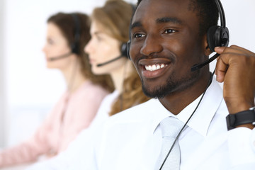 African american call operator in headset. Call center business or customer service concept