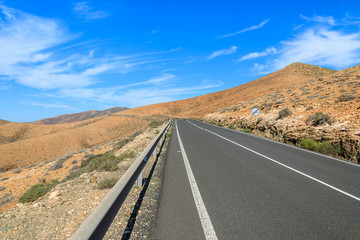 Scenic road and view of volcanic mountains near Pajara village, Fuerteventura, Canary Islands, Spain