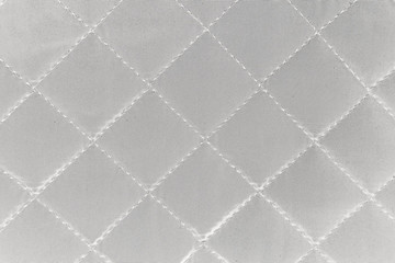 Quilted synthetic fabric texture background.