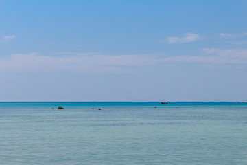 Long Tail boat in Thailand cruising on cyan blue water, panoramic