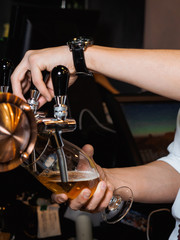 Barman pours beer