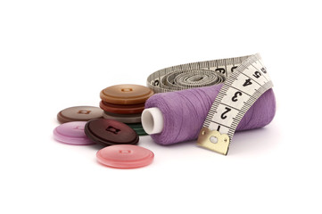 Buttons, Thread spool and Tape Measure on White Background