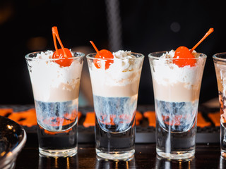 Cocktail shots on bar desk, a drop