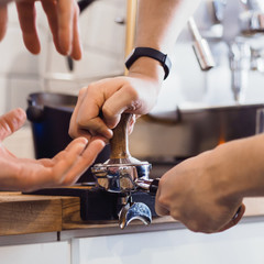 barman presses coffee