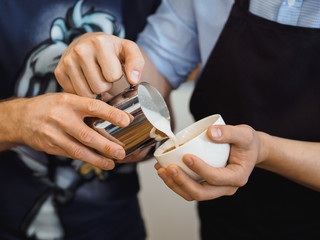 Barman pours coffee