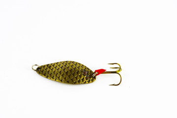 Exhibition of pirated copies of fishing metal spoon baits. Bait for fishing in the shape of a spoon with a hook on a white background
