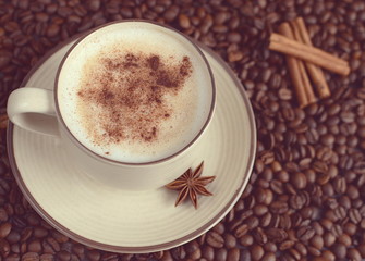 Vintage cup of hot cappuccino with steam