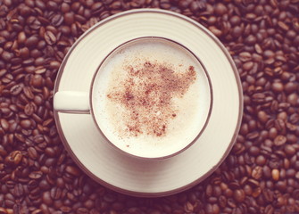 Vintage cup of hot cappuccino with steam