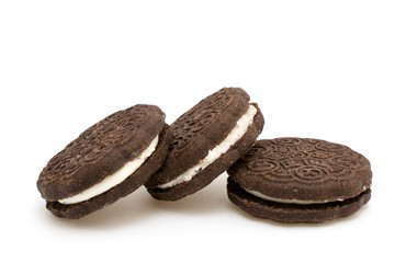 Black cookie sandwich with cream on white