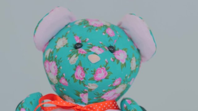 Dolly shot of teddy bear. White background. Selective focus with shallow depth of field