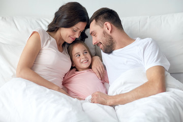 happy family in bed at home