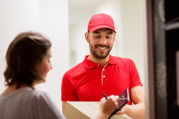 delivery man with box and tablet pc at customer
