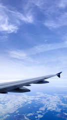Fototapeta premium Aircraft wing over the earth’s atmosphere.