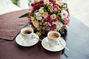  loving couple drinking coffee in a coffee shop,meeting in a cafe, a beautiful bouquet,сoffee concept