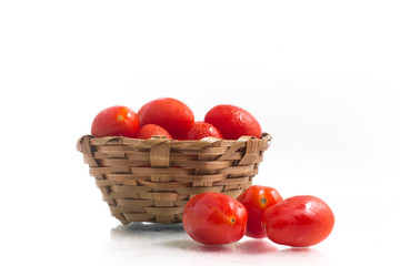 Fototapeta na wymiar Cherry Tomatoes into a basket
