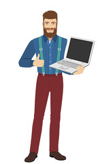 Fototapeta na wymiar Hipster holding laptop notebook and shows the thumb up