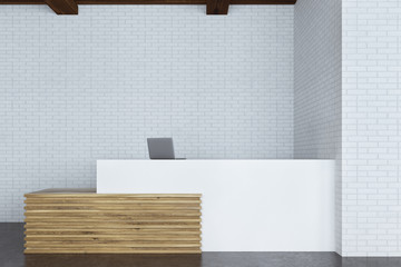 White and wooden reception with computer
