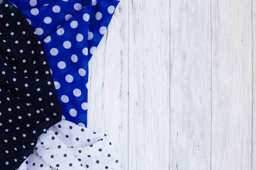 Dotted fabrics collection, copy space on white wooden background