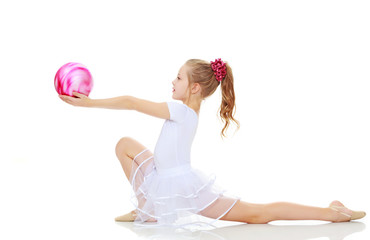 Gymnast does exercises with a ball