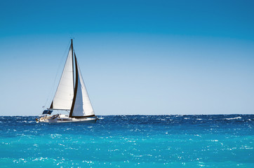 White boat sailing in the open blue sea