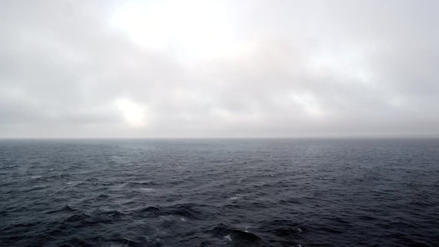 View of ocean and clouds from back of boat