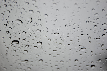 Rain drop on car glass close up background.