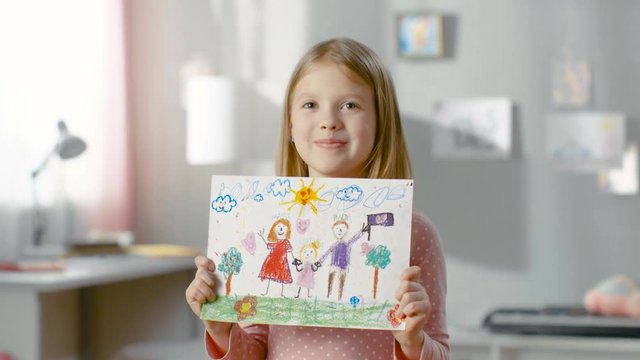 Cute Young Girl Shows Fun Drawing of Her Happy Family. Mother, Father and Her Holding Hands on the Drawing. Shot on RED EPIC-W 8K Helium Cinema Camera.