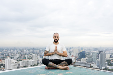 Fototapeta na wymiar Man Practice Yoga Rooftop Concept