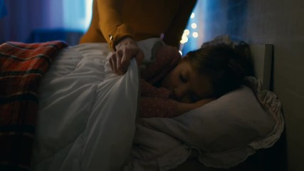 Sweet Little Girl Sleeps in Her Bed at Night, Her Mother Tucks Her Blanket in. Shot on RED EPIC-W 8K Helium Cinema Camera. - Powered by Adobe