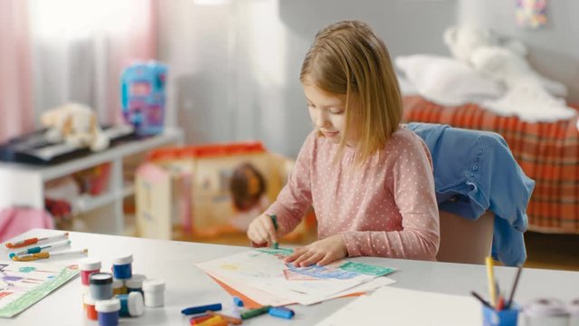Talented Little Girl in Her Room Draws With Crayons.  Shot on RED EPIC-W 8K Helium Cinema Camera.