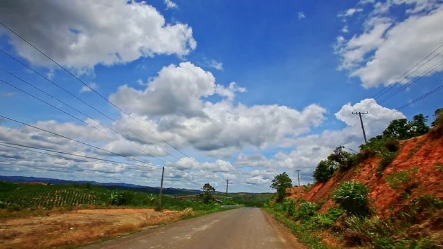 Motion along Country Road to Skyline past Forestry Hilly Slopes