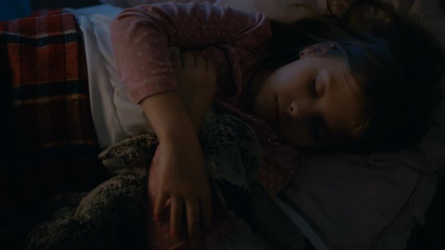  Sweet Little Girl Sleeps in Her Bed while Hugging Her Plush Toys.Shot on RED EPIC-W 8K Helium Cinema Camera.