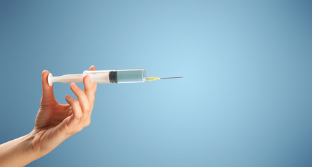 Female doctor holding syringe