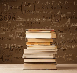 Books on vintage background with math formulas