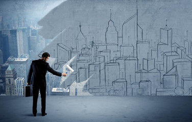 Elegant salesman repainting the city on wall